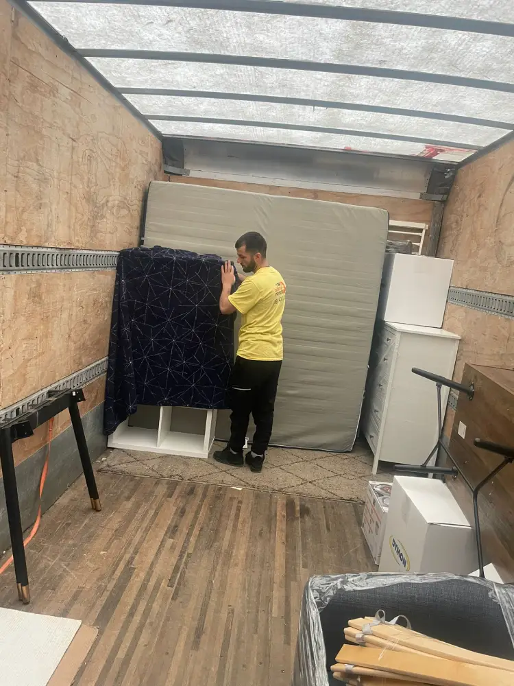 Movers inside the truck carefully loading furniture and boxes